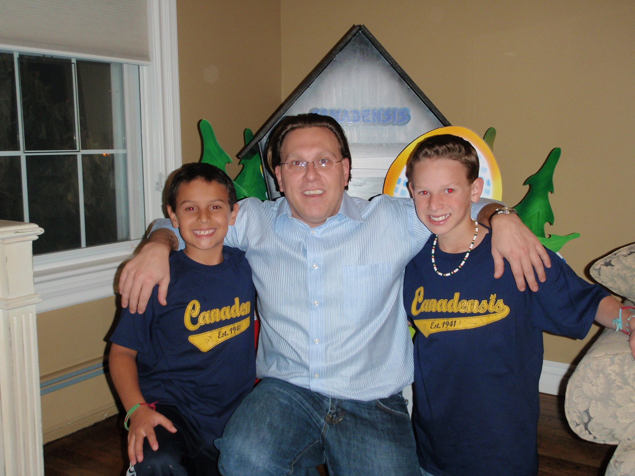 Picture 023 Me with Matthew (left) and Bradley Weltmann. We are kneeling in front of the centerpiece that was part of big sister Rachel's Bat Mitzvah. The centerpiece was all about camp!