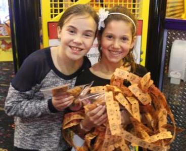 Lindsay and Amanda win an armful of tickets from all of the games.